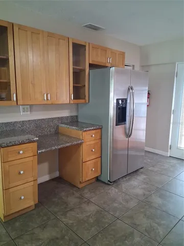a kitchen with cabinets appliances and a counter space