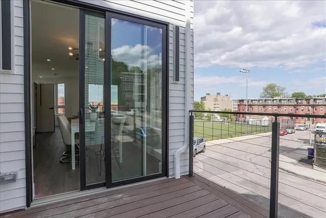 a view of a balcony with floor to ceiling window wooden floor and floor to ceiling window wooden floor
