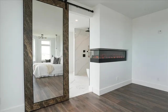an entryway and a hallway with wooden floor