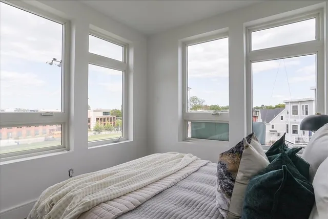 a bed sitting in a bedroom next to a window