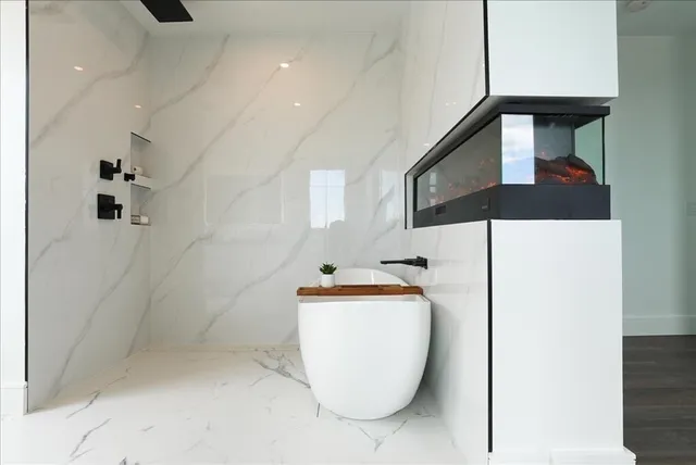a bathroom with a bathtub and shower