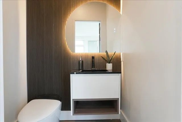 a bathroom with a toilet a sink and a window