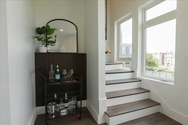 a view of entryway and hall with wooden floor