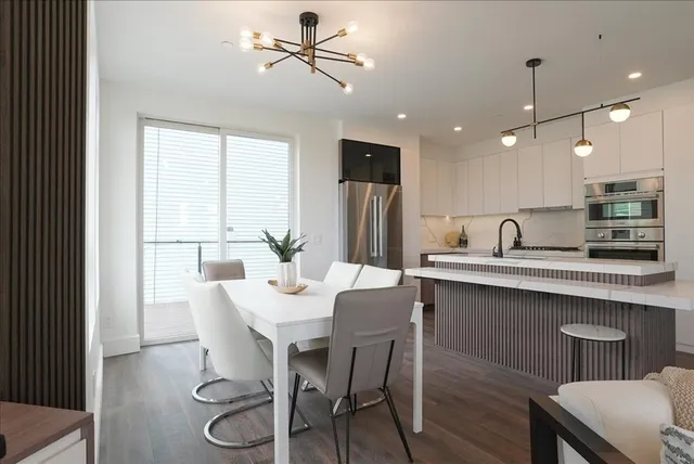 a view of a dining room with furniture window and wooden floor