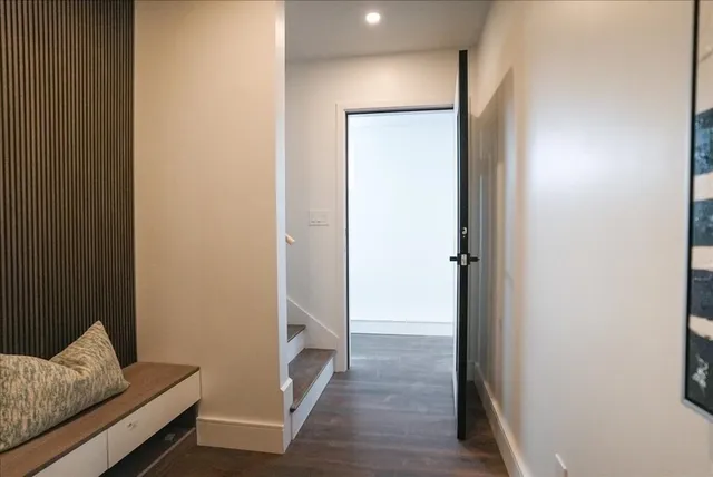 a view of an empty room and wooden floor