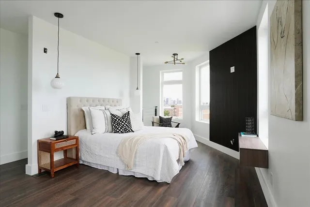 a bedroom with a bed and a mirror