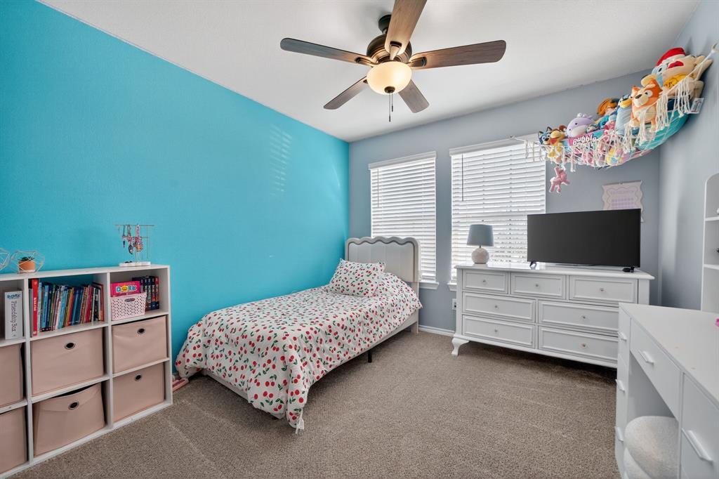 800 Rustic Way Royse City, TX 75189 - Photo 12 of 21 a bedroom with a bed and a flat screen tv