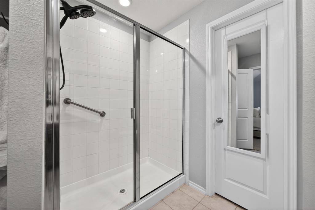 800 Rustic Way Royse City, TX 75189 - Photo 17 of 21 a bathroom with a glass shower door and a glass door