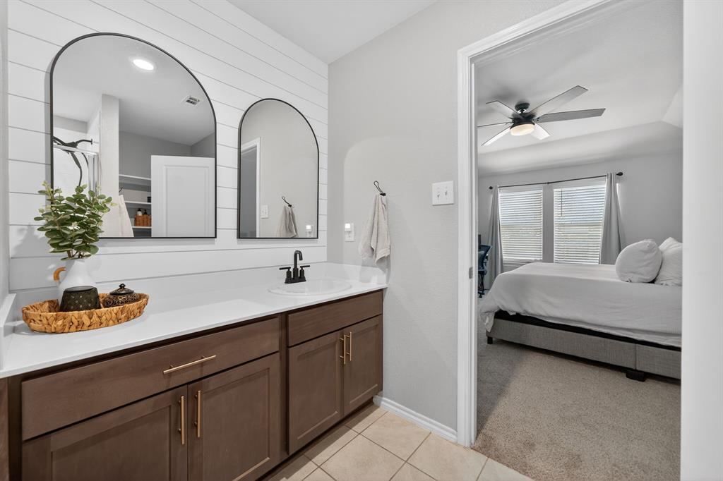 800 Rustic Way Royse City, TX 75189 - Photo 18 of 21 a en suite bathroom with a double vanity sink and a mirror