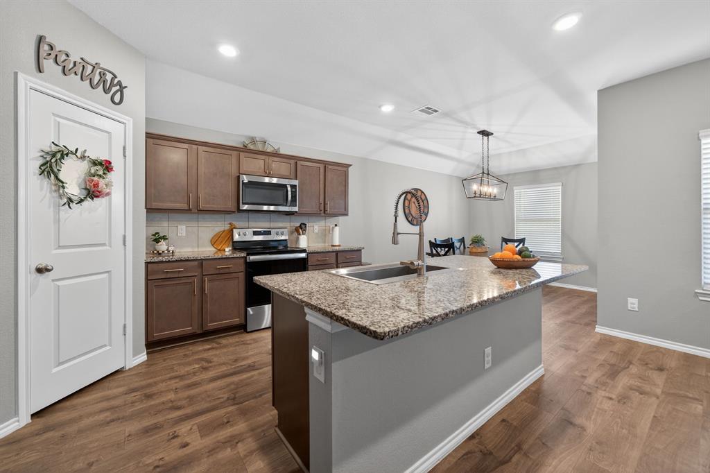 800 Rustic Way Royse City, TX 75189 - Photo 8 of 21 a kitchen with stainless steel appliances granite countertop a sink stove and refrigerator