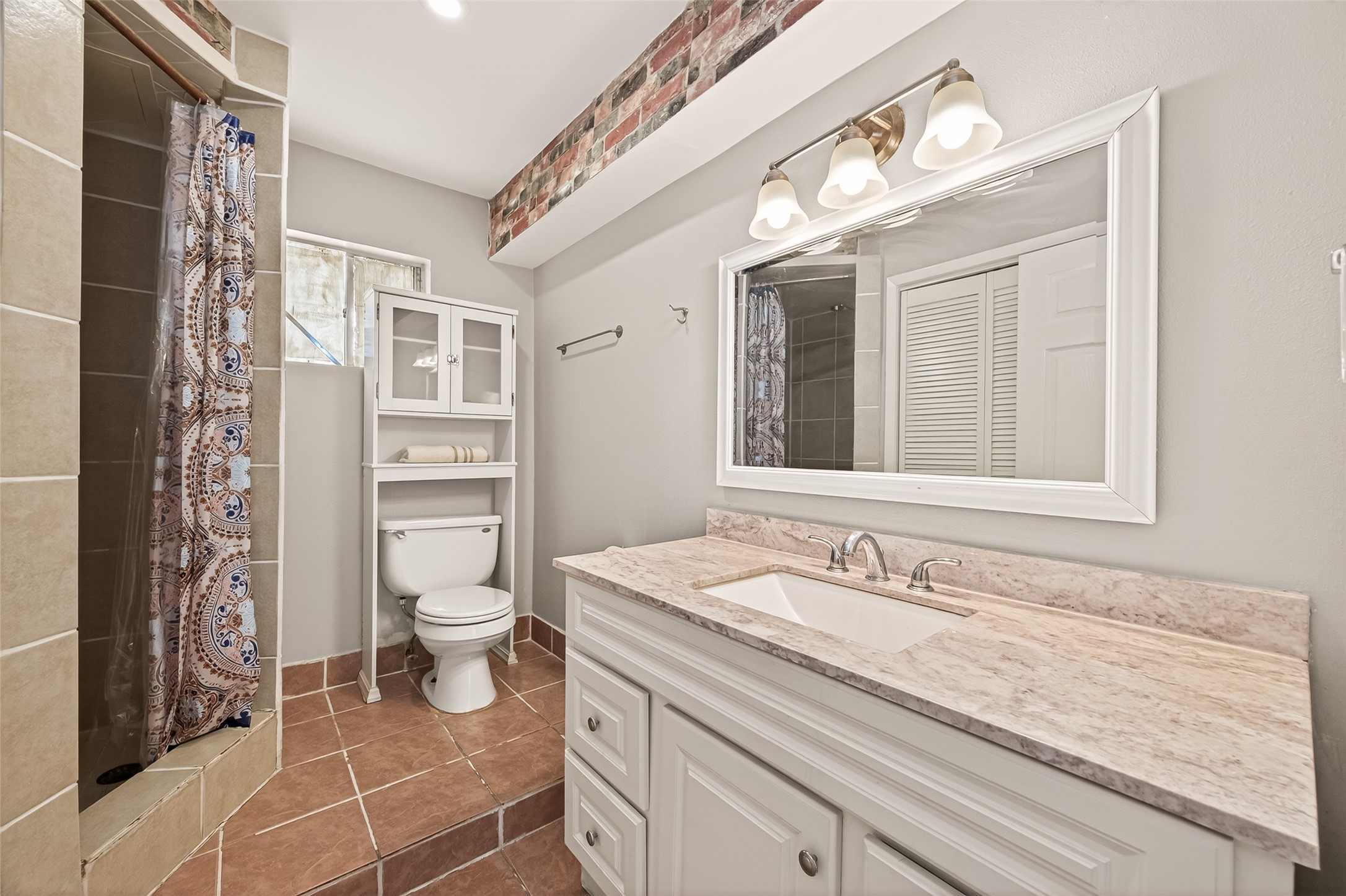 1529 Wirt Road, Unit 1 Houston, TX 77055 - Photo 9 of 16 a bathroom with a granite countertop sink mirror vanity and toilet