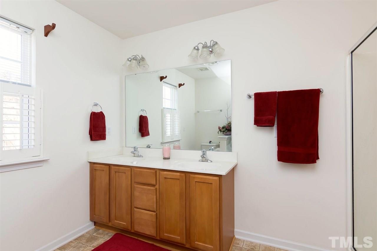 8228 Belneath Court Raleigh, NC 27613 - Photo 12 of 17 a bathroom with a sink vanity and mirror