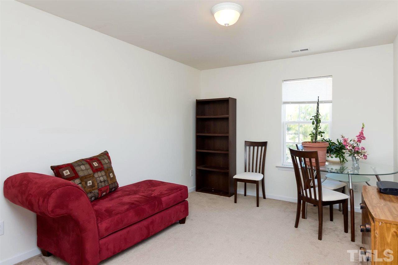 8228 Belneath Court Raleigh, NC 27613 - Photo 13 of 17 a living room with furniture and a chair