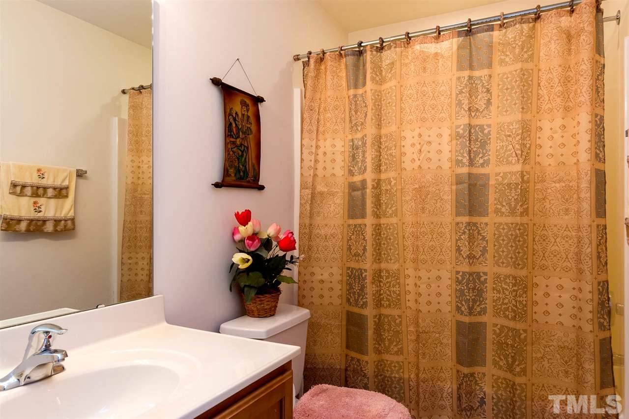 8228 Belneath Court Raleigh, NC 27613 - Photo 14 of 17 a bathroom with a sink mirror and a shower