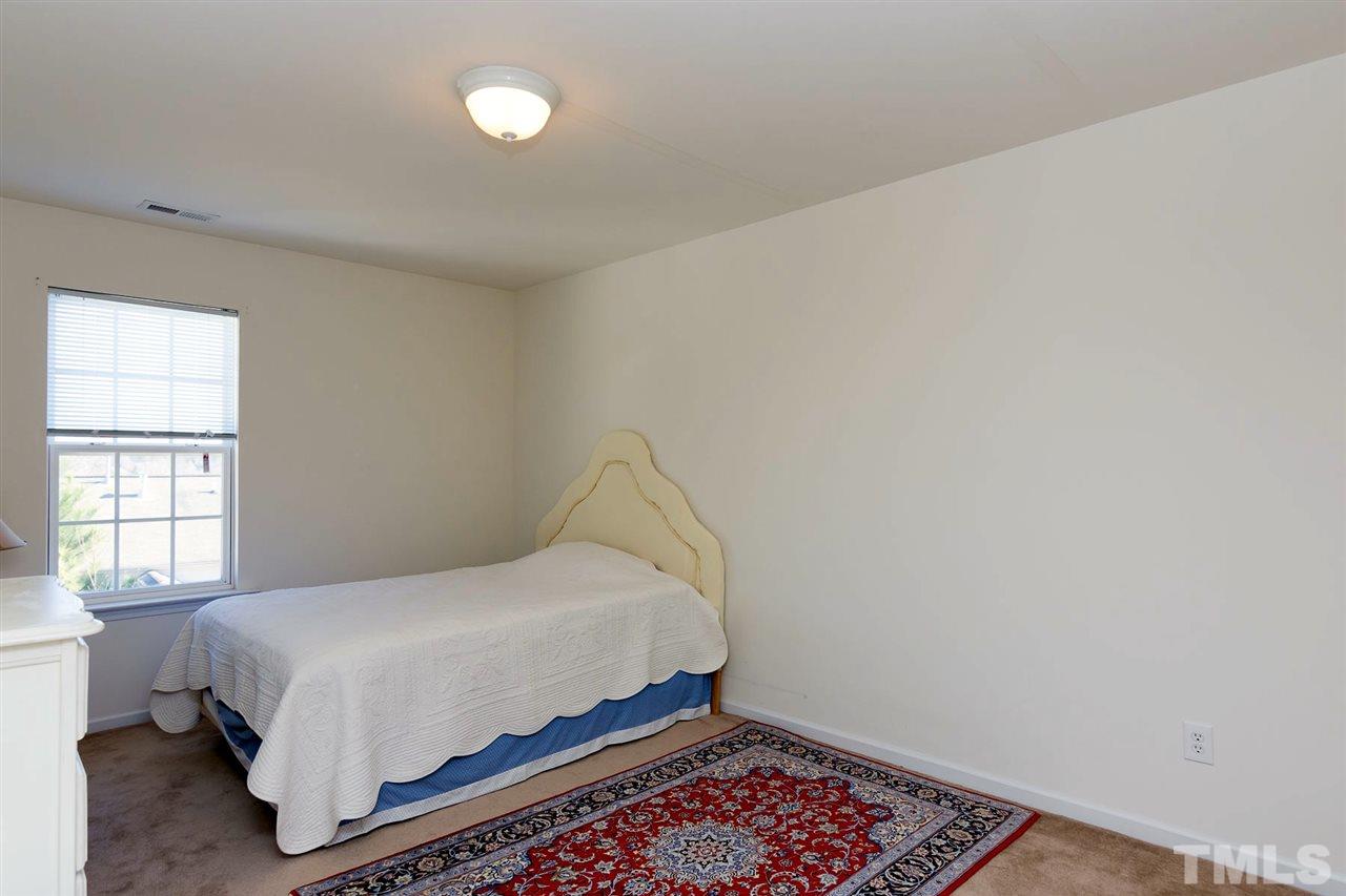 8228 Belneath Court Raleigh, NC 27613 - Photo 15 of 17 a bedroom with a bed and window