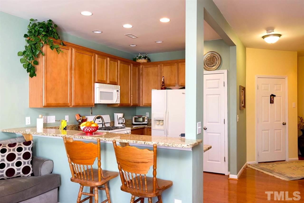 8228 Belneath Court Raleigh, NC 27613 - Photo 5 of 17 a kitchen with stainless steel appliances granite countertop a refrigerator and a stove top oven