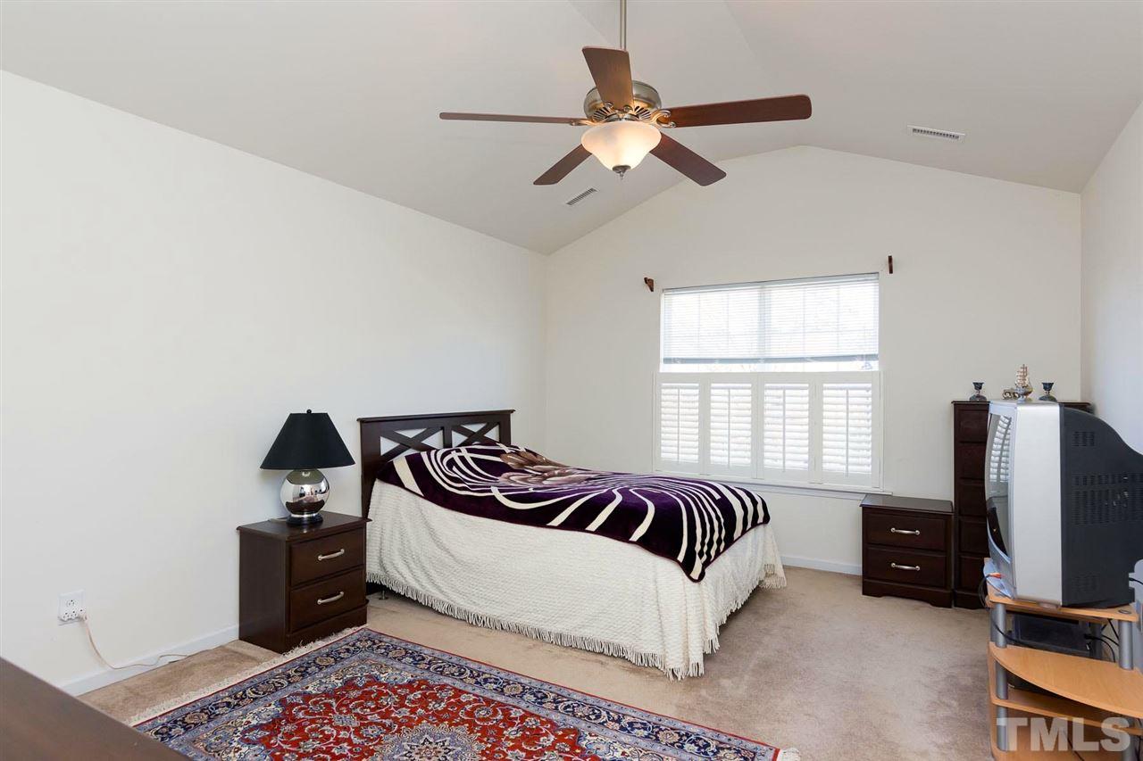 8228 Belneath Court Raleigh, NC 27613 - Photo 10 of 17 a bedroom with a bed and a television
