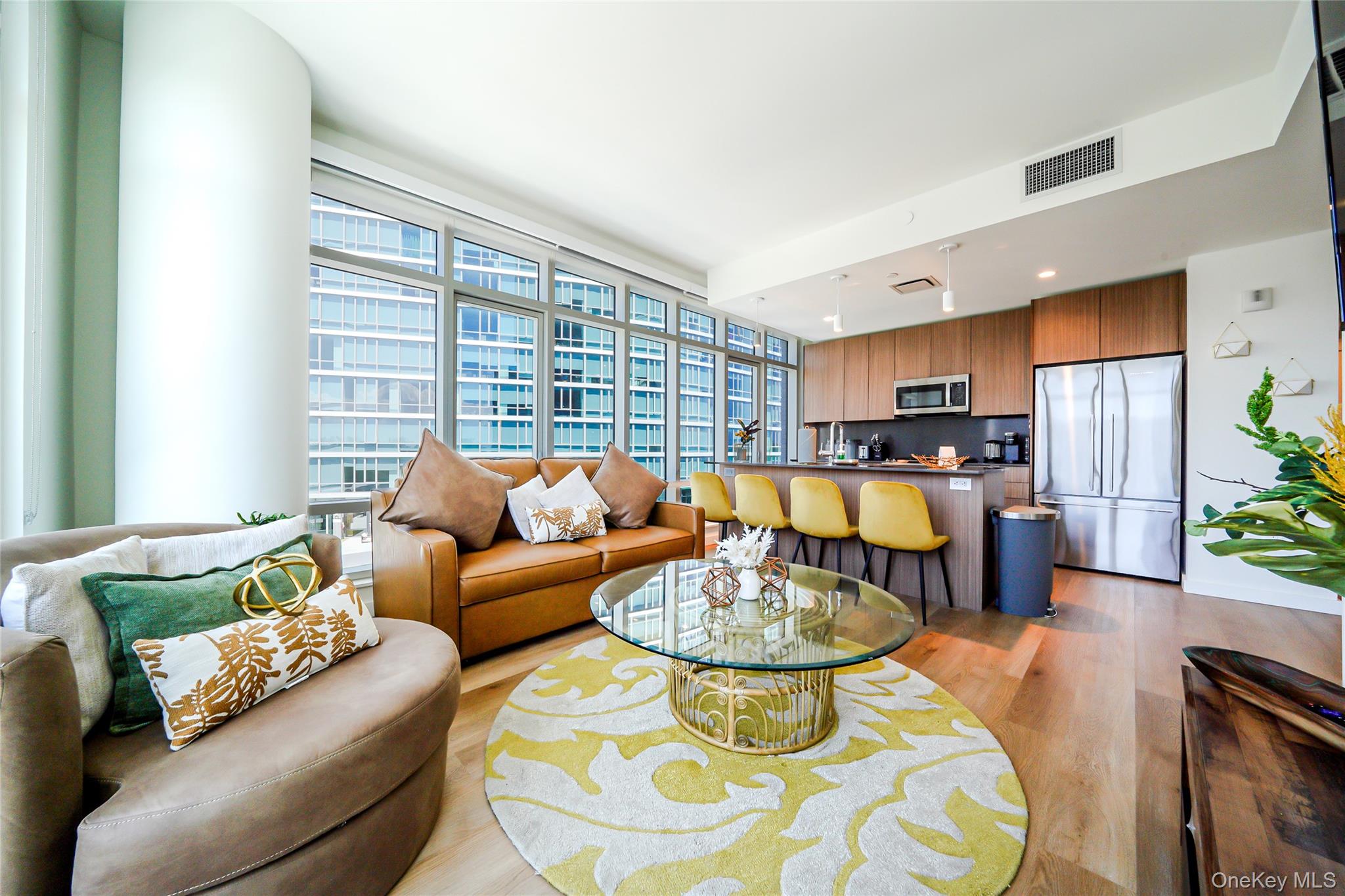 a living room with furniture and a dining table