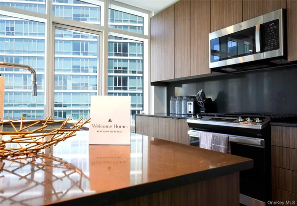 a kitchen with stainless steel appliances wooden cabinets a stove and a microwave