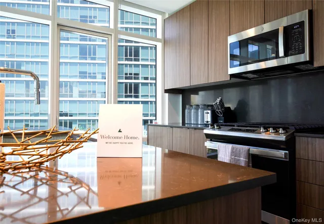 a kitchen with stainless steel appliances wooden cabinets a stove and a microwave