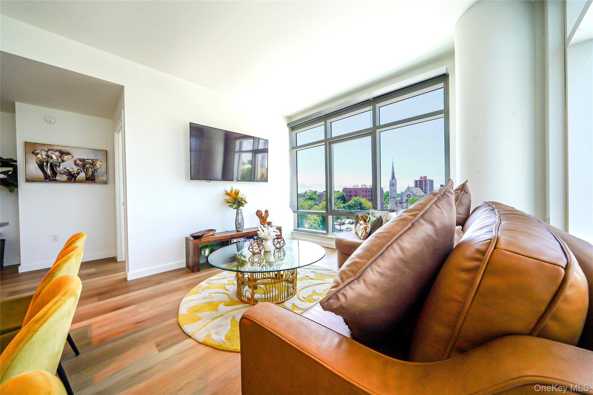 50 Clinton Place, Unit LOCUST STREET New Rochelle, NY 10801 - Photo 13 of 15 a living room with furniture and a floor to ceiling window