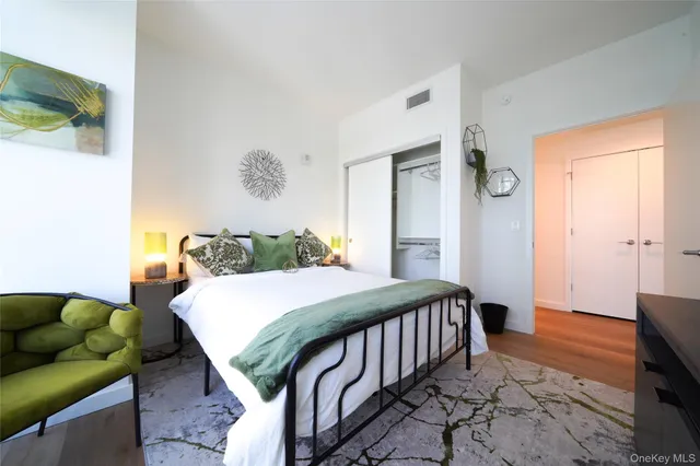 a bedroom with a bed and wooden floor