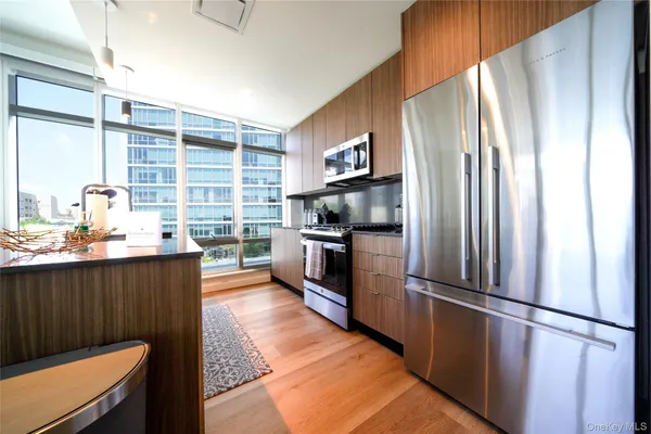 a kitchen with stainless steel appliances a refrigerator and a stove top oven