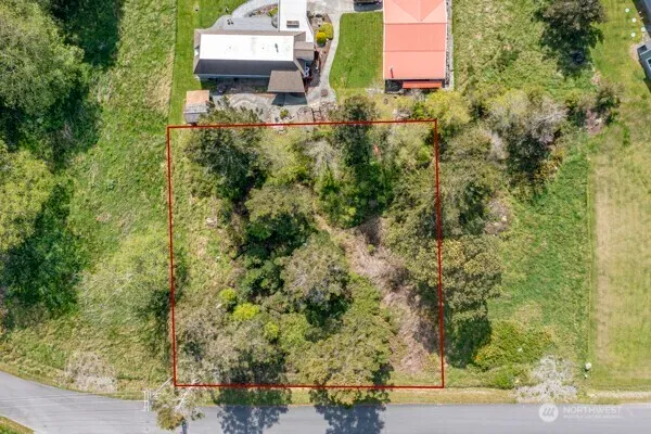 an aerial view of a house with a yard basket ball court and outdoor seating