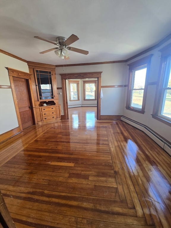 1942 Acushnet Avenue, Unit 2 New Bedford, MA 02745 - Photo 1 of 10 a view of a livingroom with wooden floor and a ceiling fan