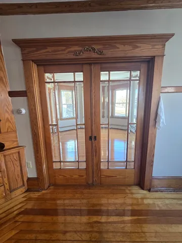 a view of entryway and hall with wooden floor