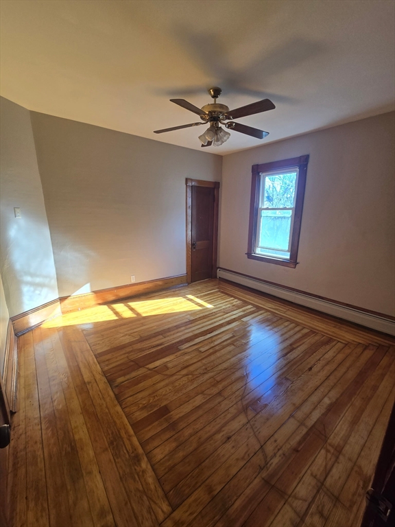 1942 Acushnet Avenue, Unit 2 New Bedford, MA 02745 - Photo 5 of 10 a view of empty room with window and wooden floor