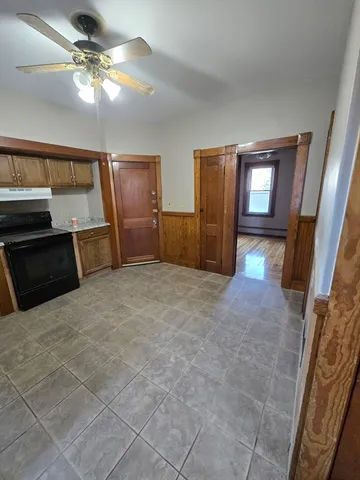 a bedroom with furniture and a chandelier fan