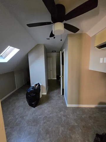 a view of a livingroom with a ceiling fan and window