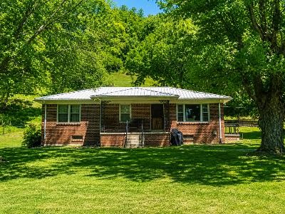 202 Maggart Road Elmwood, TN 38560 - Photo 3 of 34 a front view of a house with a yard table and chairs