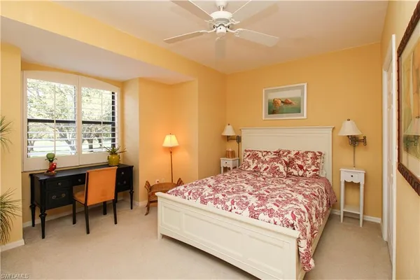 a bedroom with a bed and a table
