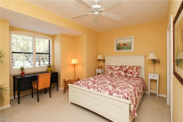 a bedroom with a bed and a table