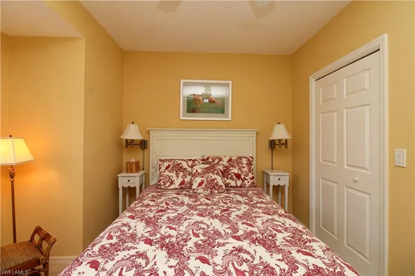 a bed sitting in a bedroom next to a bathroom