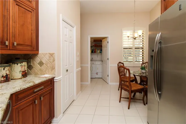 a kitchen with granite countertop furniture and a refrigerator