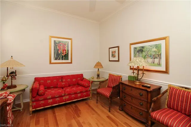 a living room with furniture a couch and paintings on the wall
