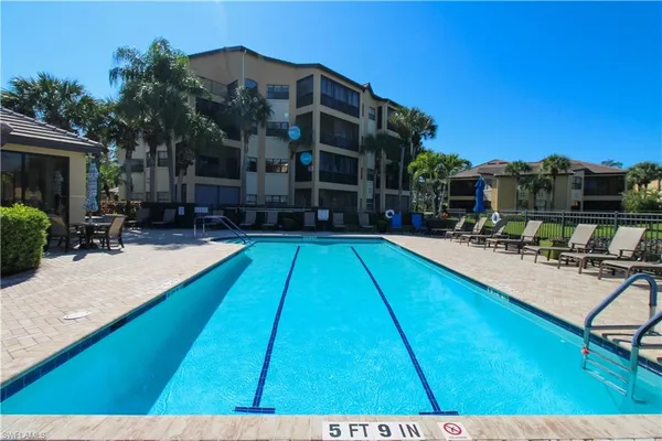a view of swimming pool with outdoor seating and a potted plant