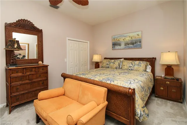 a bedroom with a bed and cabinet