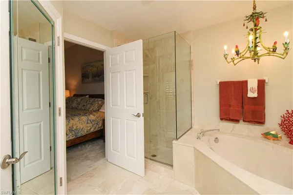 a bathroom with a tub sink and mirror