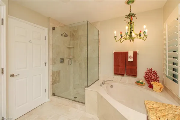 a bathroom with a tub sink and mirror