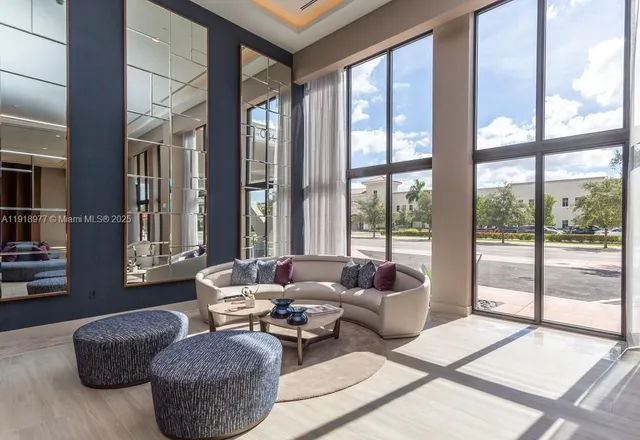 a living room with furniture and a large window