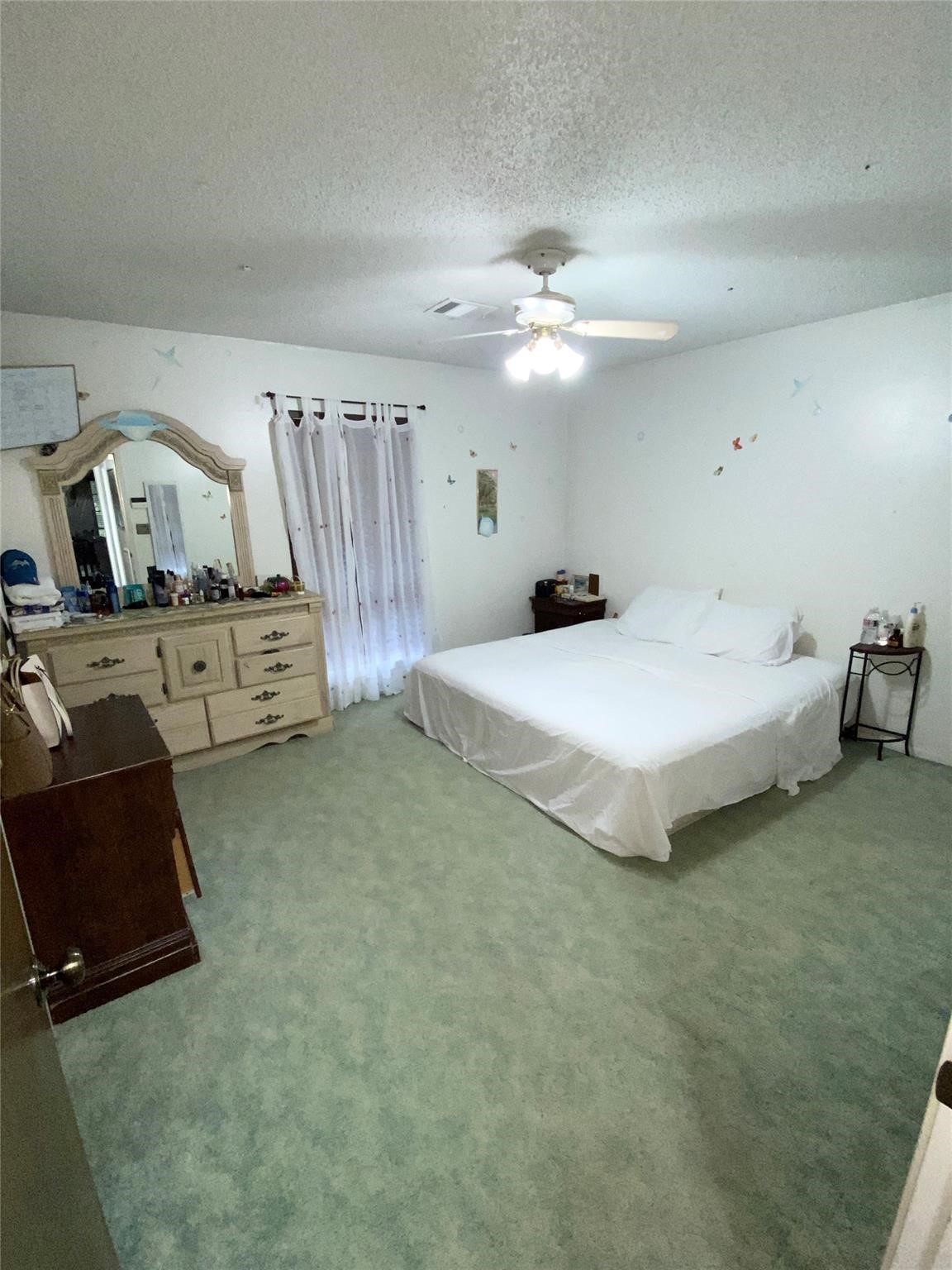 14107 Waterville Way Houston, TX 77015 - Photo 8 of 12 a spacious bedroom with a bed and ceiling fan