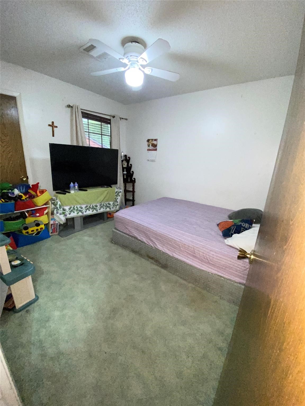 14107 Waterville Way Houston, TX 77015 - Photo 10 of 12 a bedroom with a bed and a flat screen tv