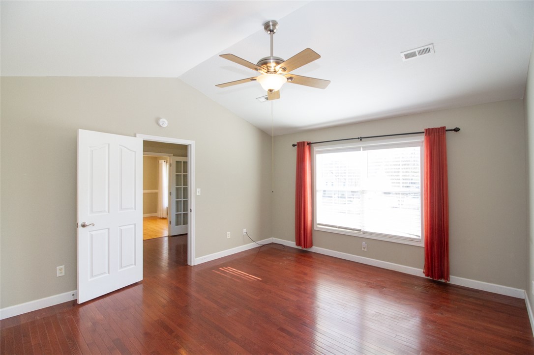 735 Britton Street Anderson, SC 29621 - Photo 24 of 50 This versatile room features warm hardwood floors and a vaulted ceiling with a fan.