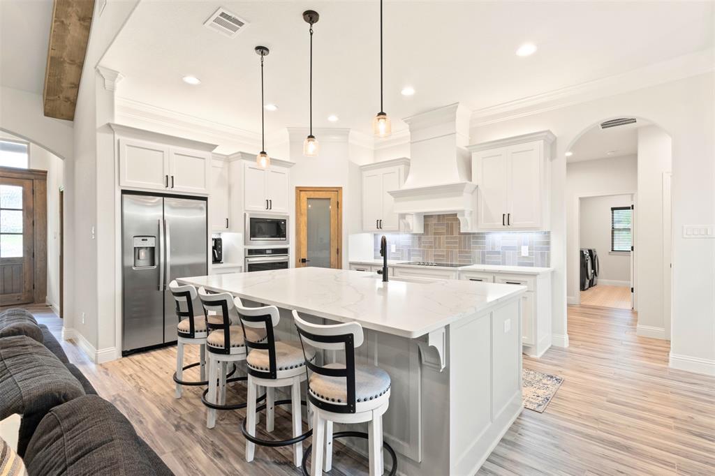 105 Clayton Crossing Springtown, TX 76082 - Photo 7 of 40 a large kitchen with a table and chairs