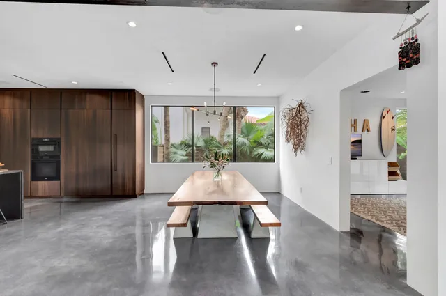 a spacious bedroom with a bed and a chandelier