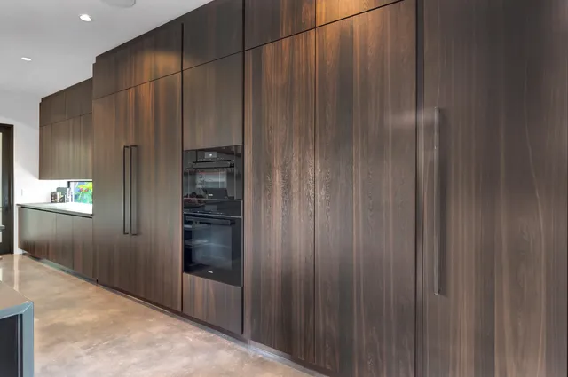 a bedroom with furniture and a large window